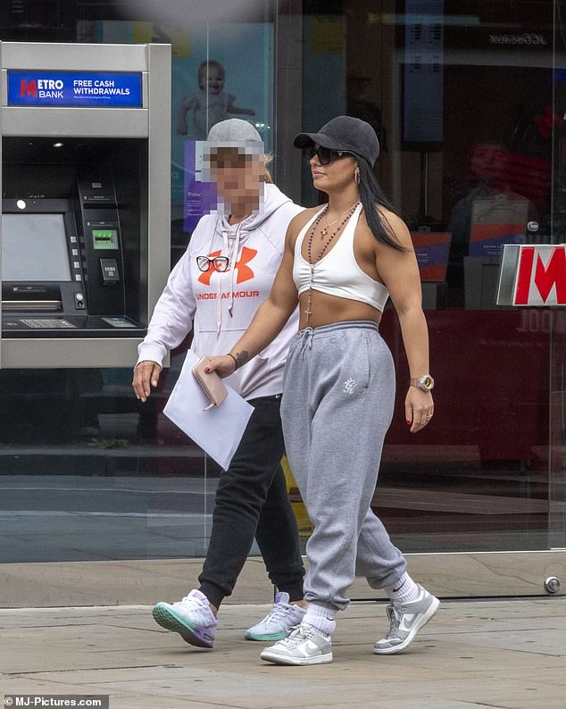 She was photographed wearing a gold band on the ring finger of her left hand while shopping with another woman.