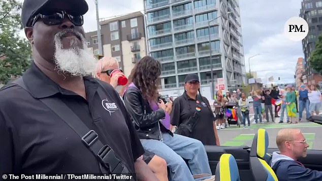 A security guard blocks a journalist who tries to question Rapinoe about her controversial views.