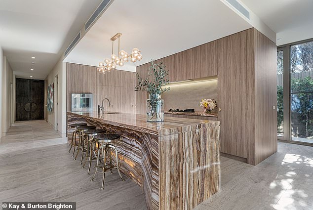 The beautiful kitchen with breakfast bar. (Pictured)