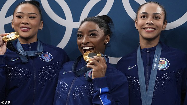 From left, Suni Lee, Simone Biles and Hezly Rivera celebrate after winning the gold medal.