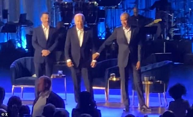 Obama is seen gently tugging on Biden's arm and leading him off the stage after the president froze during applause at a fundraiser in Los Angeles in June.