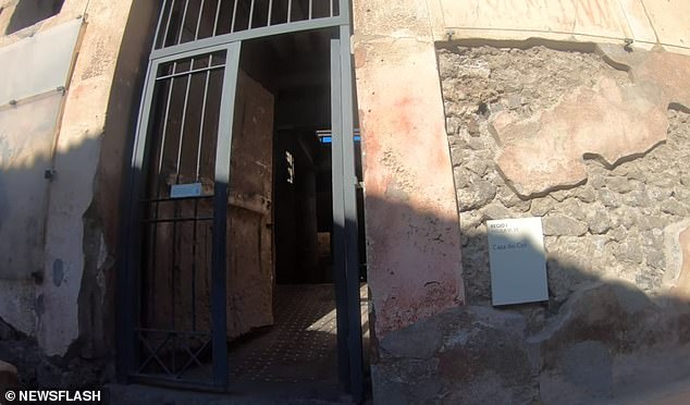 The entrance to the ancient villa, which is a popular spot for tourists visiting the site.