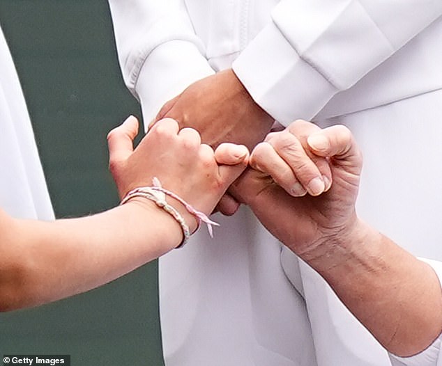 In a sweet moment, the nine-year-old royal intertwined her pinky fingers with the wheelchair tennis player's.