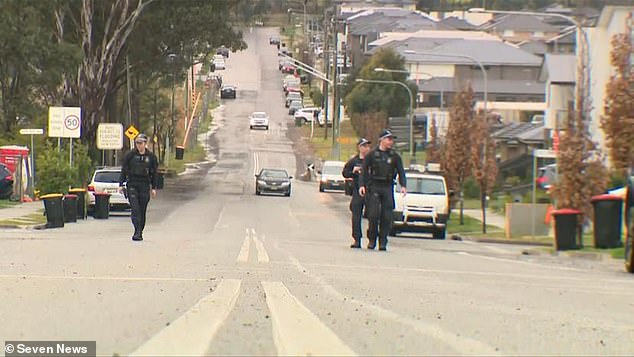 Police appear at the scene in Austral, south-west of Sydney, where a barefoot worker chased a suspected gunman on Thursday night.