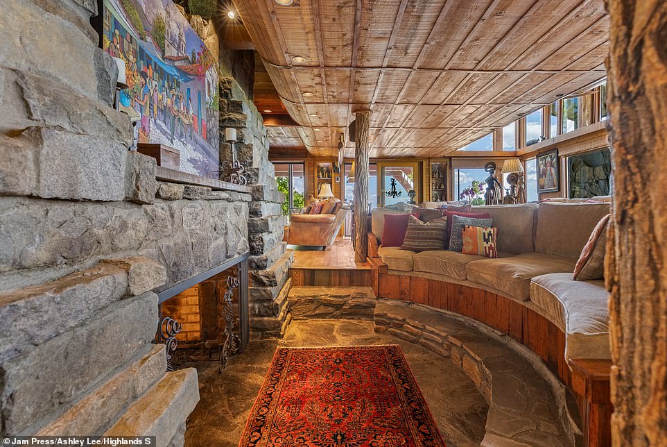 The sunken living room, believed to have once hosted stars including Sally Field and James Garner, features a large stone fireplace.