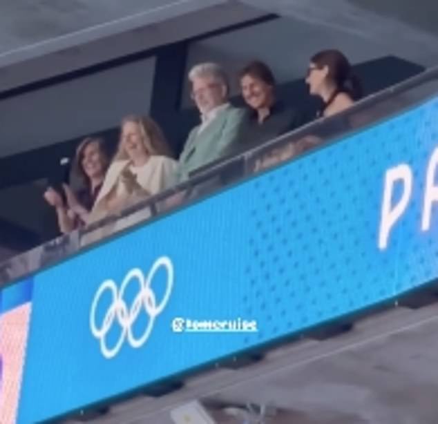 The Hollywood actor blew kisses to fans as he watched a swimming relay event after cheering on Simone Biles in women's gymnastics.