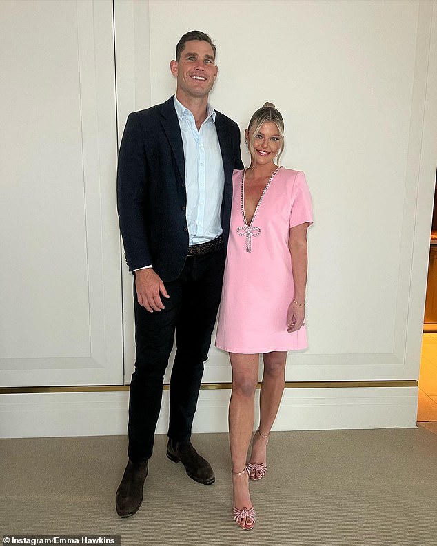 Emma welcomed her third child, Henry, with her husband, Geelong football champion Tom Hawkins, in July 2022. They are both pictured.