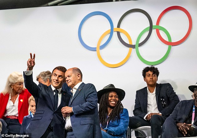 President Emmanuel Macron (left) speaks with German Chancellor Olaf Scholz (right) at the opening ceremony