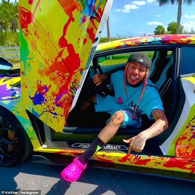 The rapper's paint-splattered sports cars were sold at auction after the IRS seized them from his Florida home in April.