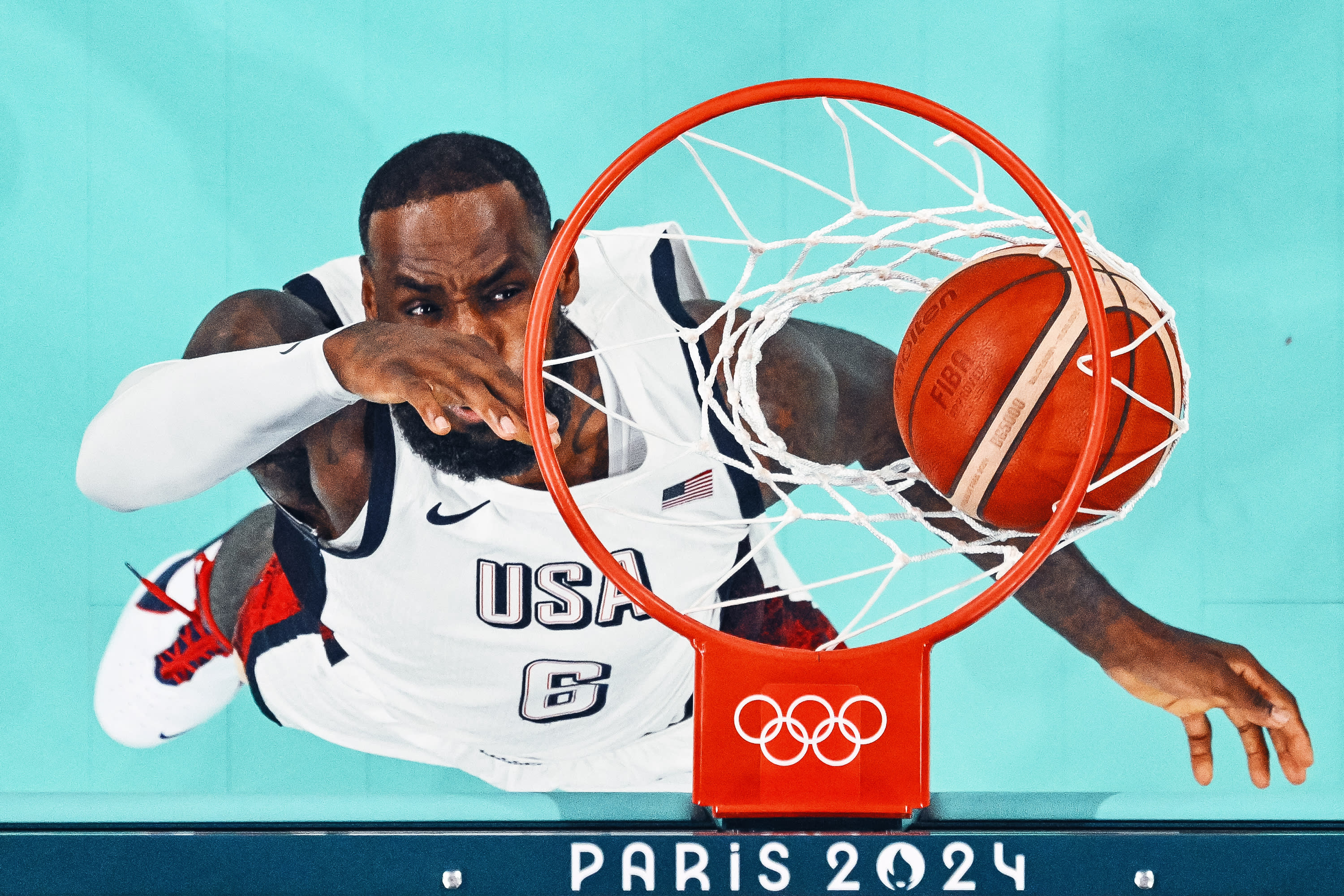 A general view shows USA's No. 06 LeBron James scoring a basket during the men's preliminary round group C basketball match between USA and South Sudan during the Paris 2024 Olympic Games at Pierre-Mauroy stadium in Villeneuve-d'Ascq, northern France, on July 31, 2024. (Photo by SAMEER AL-DOUMY/POOL/AFP via Getty Images)