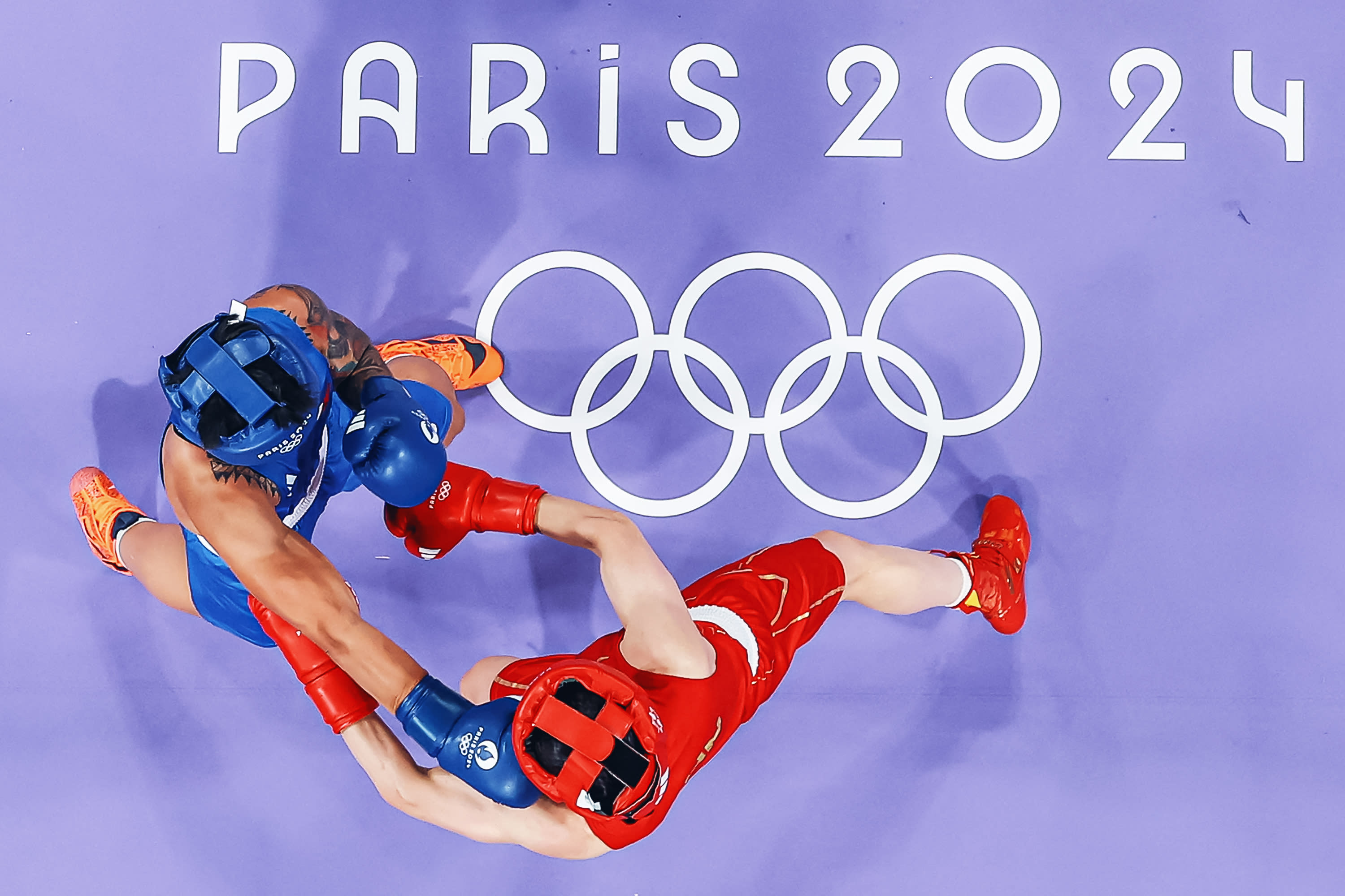 A general view shows Hergie Bacyadan of the Philippines (in blue) fighting against Li Qian of China in the women's 75kg preliminary round of 16 boxing match during the Paris 2024 Olympic Games at the North Paris Arena, in Villepinte on July 31, 2024. (Photo by -/POOL/AFP via Getty Images)