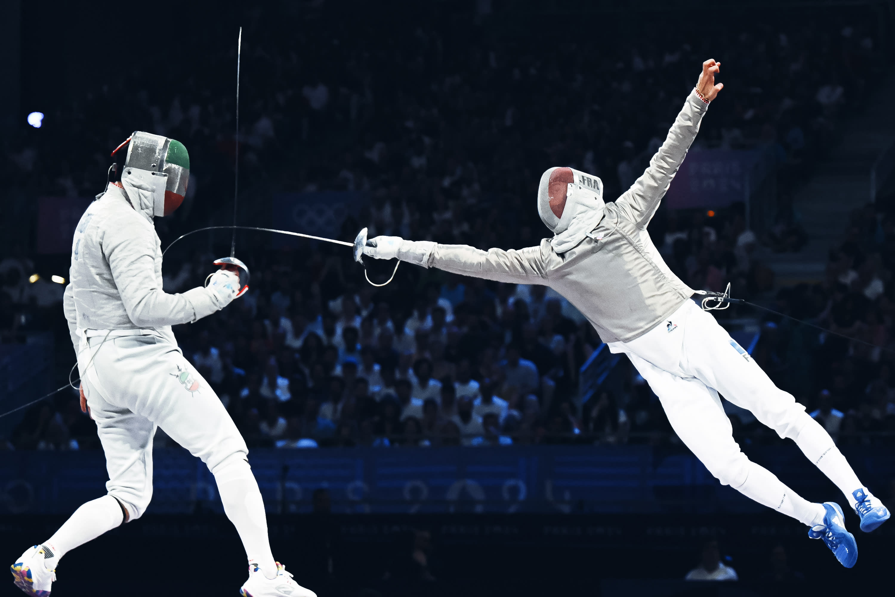 Iran's Mohammad Rahbari Koyakhi (L) competes against France's Sebastien Patrice in the bronze medal match in the men's team sabre between Iran and France during the Paris 2024 Olympic Games at the Grand Palais in Paris, on July 31, 2024. (Photo by FABRICE COFFRINI/AFP via Getty Images)