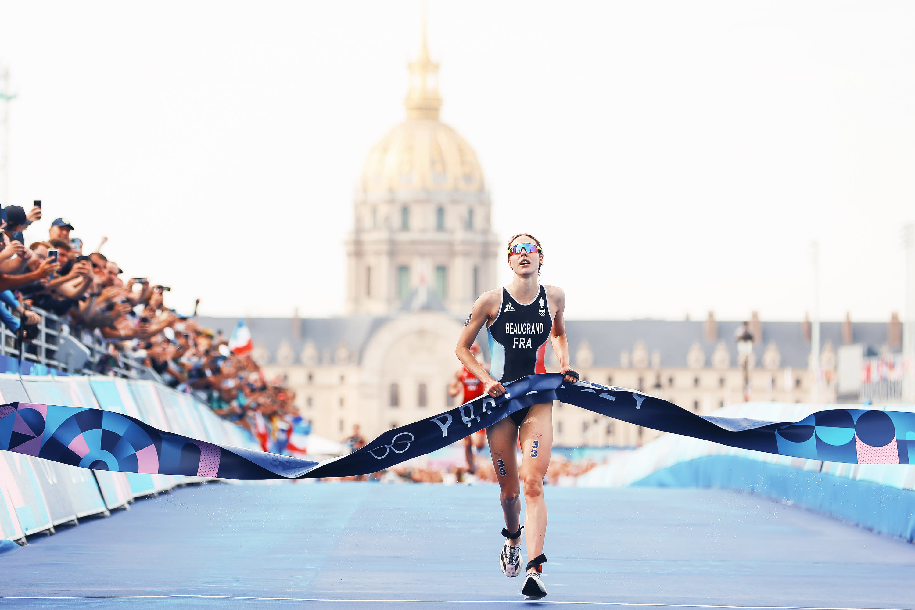 Cassandre Beaugrand of Team France crosses the finish line to win the gold medal after competing in the Women's Individual Triathlon on day five of the Paris 2024 Olympic Games at the Pont Alexandre III on July 31, 2024 in Paris, France. (Photo by Michael Steele/Getty Images)