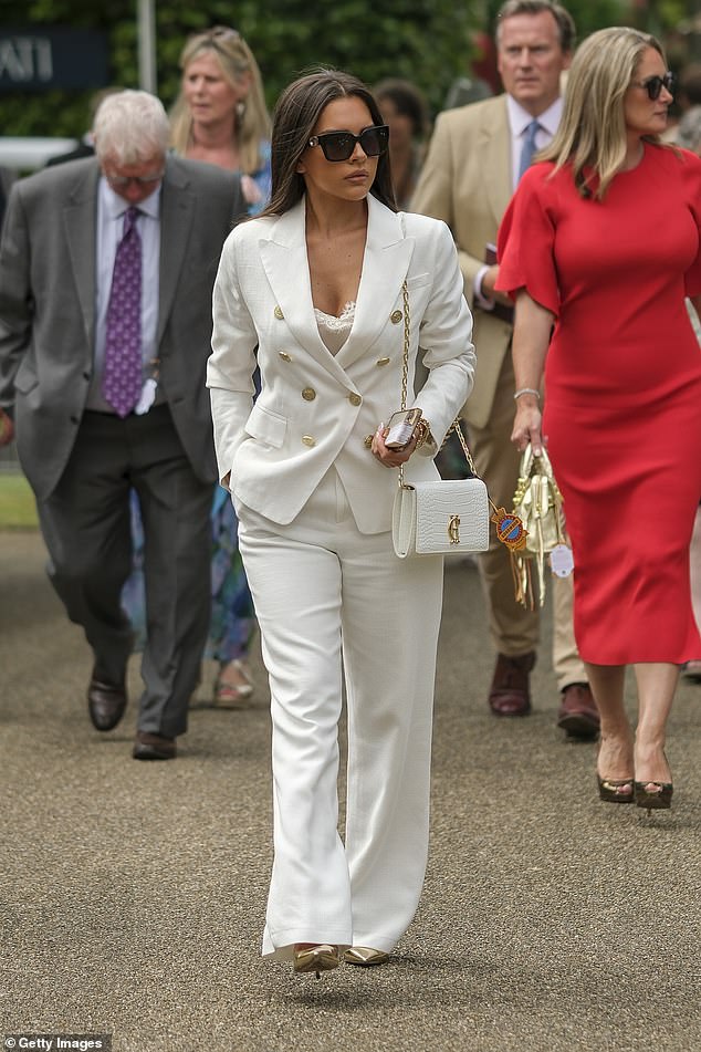 Gemma accessorized the look with oversized black sunglasses, accentuating her height with gold stilettos and completing the look with a white handbag.