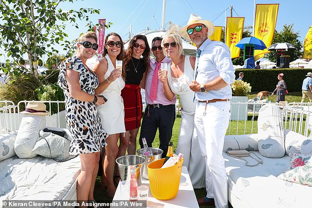 Feet up! Many race-goers enjoyed the sun with bottles of champagne