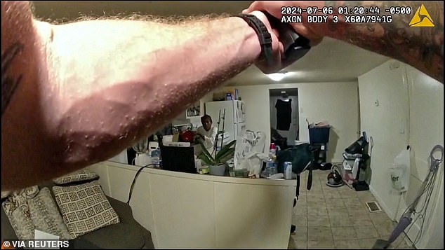 Officer Sean Grayson draws his gun as Sonya Massey hides in her kitchen on July 6.