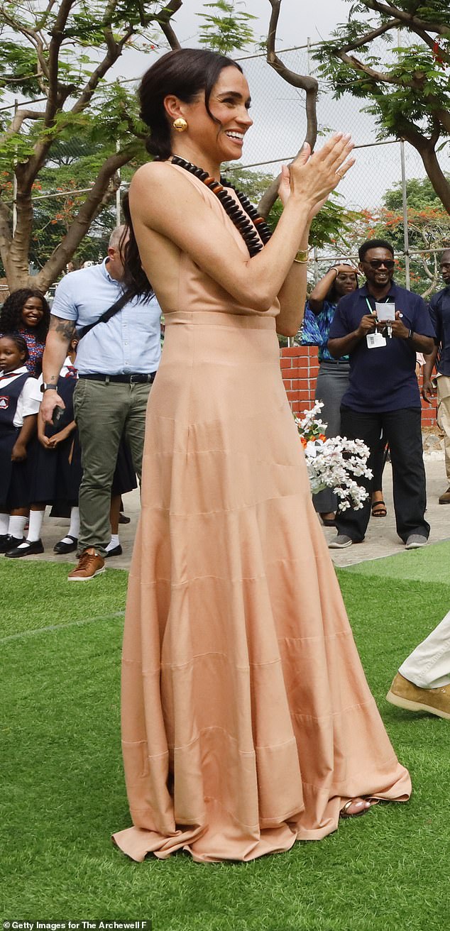 Meghan Markle wears a long ruffled dress during her visit to Lightway Academy in Abuja, Nigeria, in May 2024