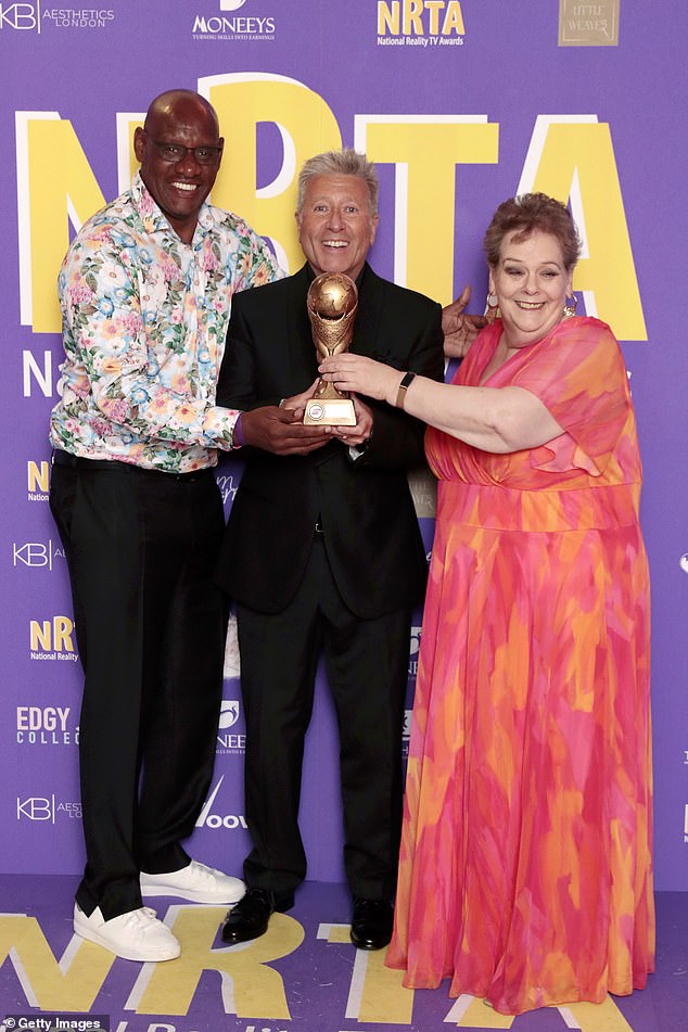 The DJ presented The Chase's Shaun Wallace (L) and Anne Hegerty (R) with the award for Best Game Show and then playfully posed with the pair.