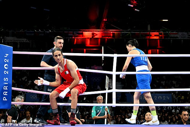 The Italian fighter (in blue) refused the handshake and fell to the canvas, apparently wiping away a tear. Winner Khelif is pictured in red as her opponent leaves the ring.