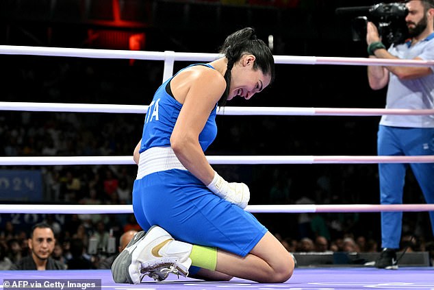 The Italian boxer fell to her knees after withdrawing and was seen crying in the ring