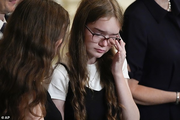 Miriam Butorin, 13, wipes away a tear at the White House event