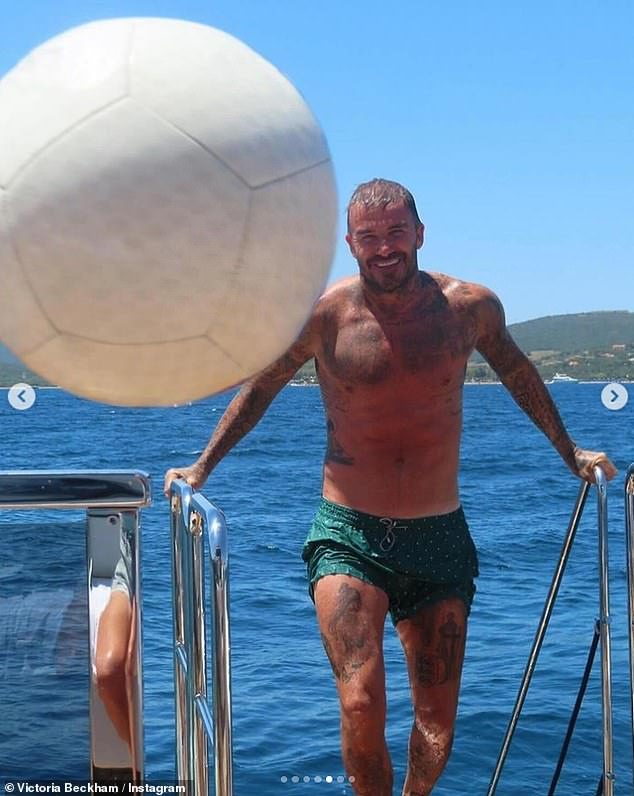 Former footballer David made the most of the sunshine as he stripped down to his green swimming trunks, showing off his muscular, tattooed physique.