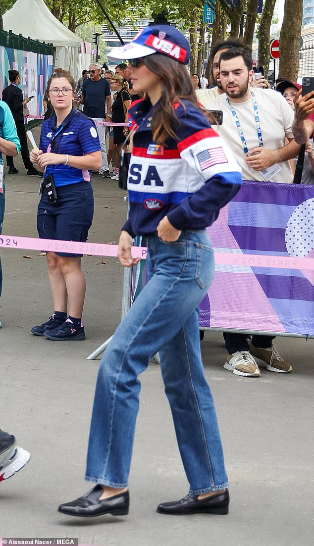 The fashionista wore straight-leg blue jeans, black loafers and a Team USA bomber jacket.