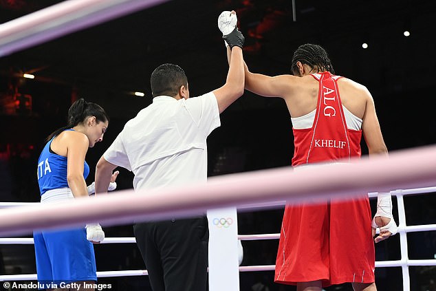 The judge raises Khelif's arm, signifying his victory over Carini.