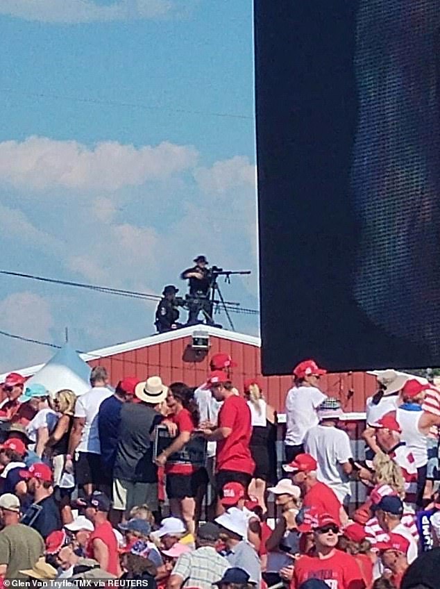 Snipers stand on a rooftop during a campaign rally for Republican presidential candidate and former US President Donald Trump