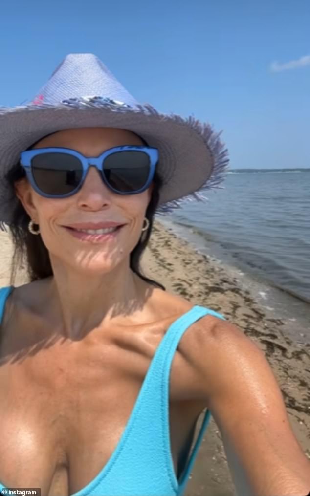 The fashionista added chic blue-framed sunglasses and small hoop earrings during her solo walk on the beach.