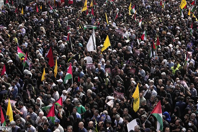 Iranians gather for the funeral ceremony of Hamas leader Ismail Haniyeh and his bodyguard, who were killed in an assassination blamed on Israel, on Wednesday, in Enqelab-e-Eslami.