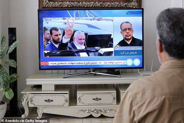 A man watches the news on a television after Hamas political bureau chief Ismail Haniyeh was killed in an Israeli airstrike on his residence in the Iranian capital Tehran, Iran, July 31, 2024.