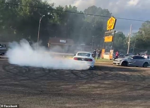 His video showed cars revving their engines and doing donuts in the middle of a busy street.