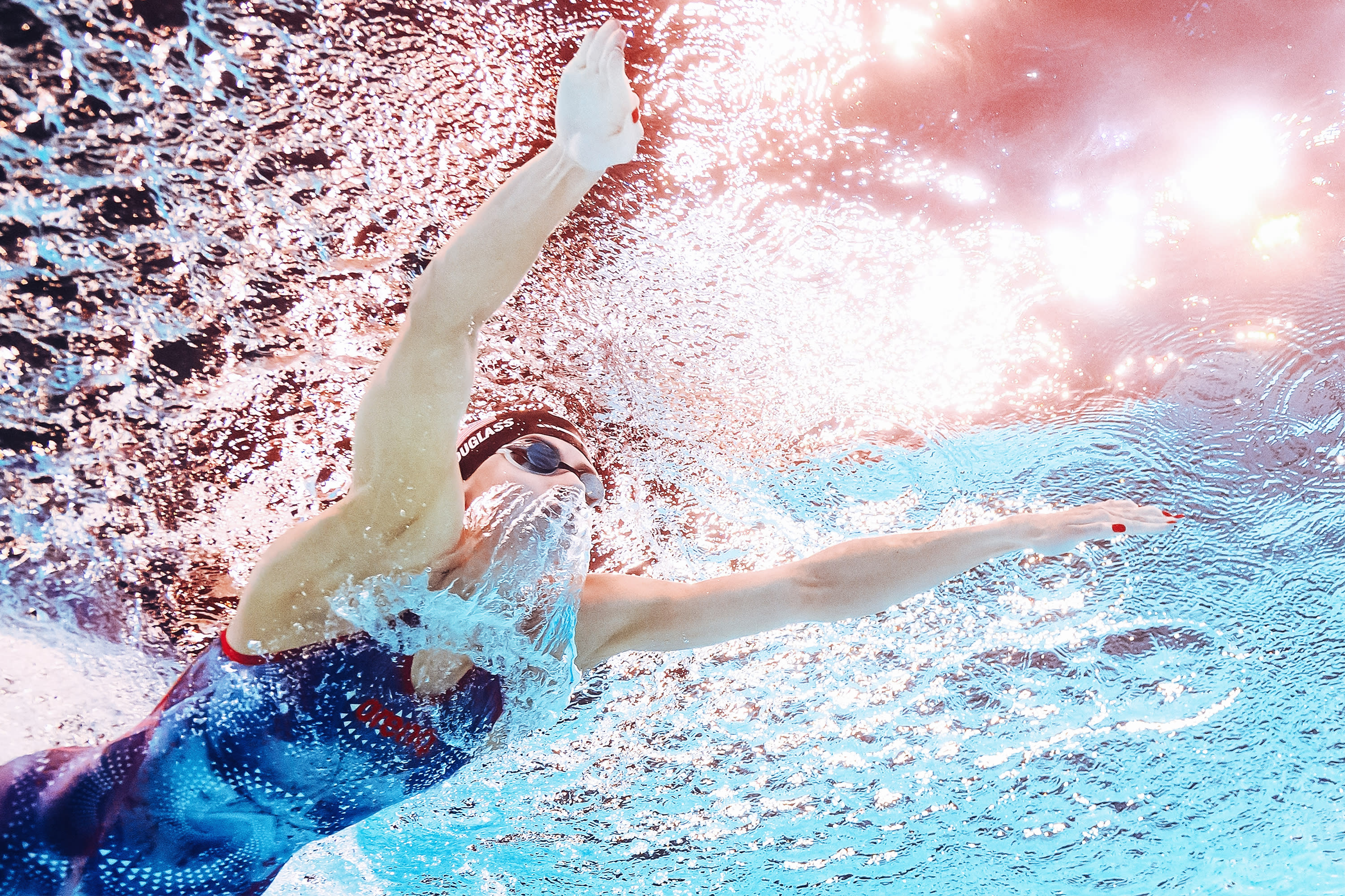 An underwater view shows American Kate Douglass competing in the final of the women's 200m breaststroke swimming event during the Paris 2024 Olympic Games at the Arena Paris La Defense in Nanterre, west of Paris, on August 1, 2024. (Photo by MANAN VATSYAYANA/AFP via Getty Images)