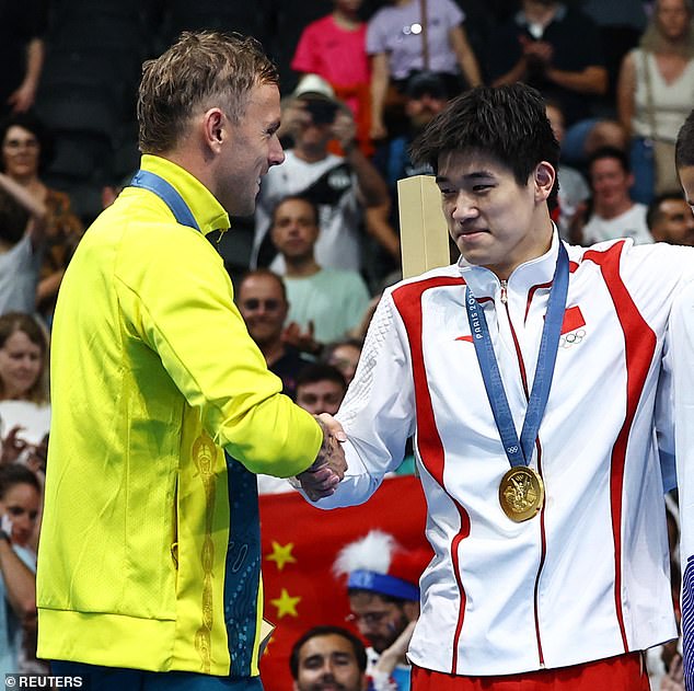 Chalmers was photographed warmly shaking Pan's hand after receiving his medals.