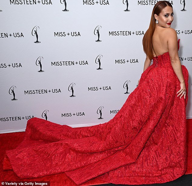 Her sumptuous gown featured an extravagantly long train that stretched luxuriously behind her on the red carpet, matching