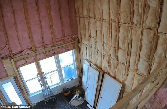 The drywall has been removed from the interior of the house, leaving the beams exposed throughout.