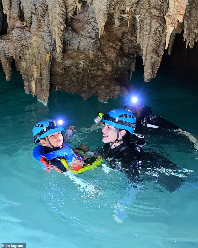 Kat gave her son a bright smile as she swam with him and explored the picturesque area.