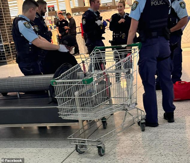 Footage from the scene showed a man sitting with officers surrounding him at Chullora Market.