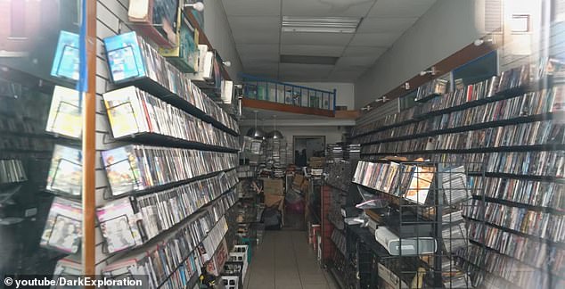 A closed video game store has hundreds of games on the shelves that gradually age.