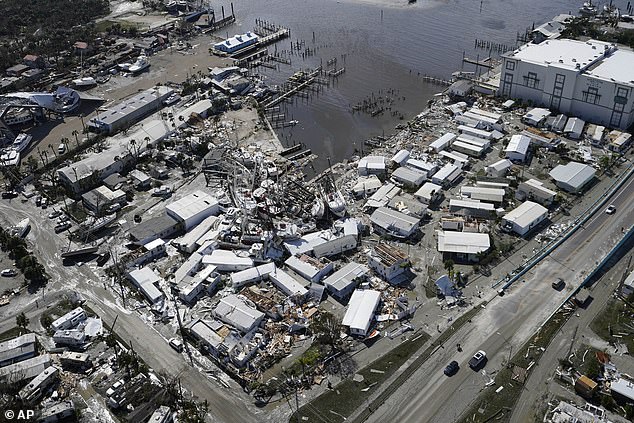 Damaged boats lie on land and in the water following Hurricane Ian, Thursday, Sept. 29, 2022, in Fort Myers, Fla.