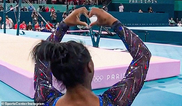 Biles returned the heart symbol with her hand to Owens, who has been nicknamed the 