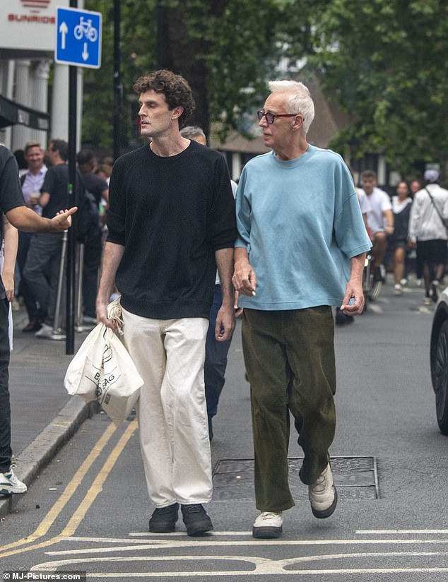 The duo looked in good spirits as they strolled through the bustling streets of London.