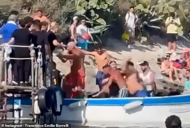 The fight quickly spread from the boat to the dock as the men in bathing suits kicked and punched each other.