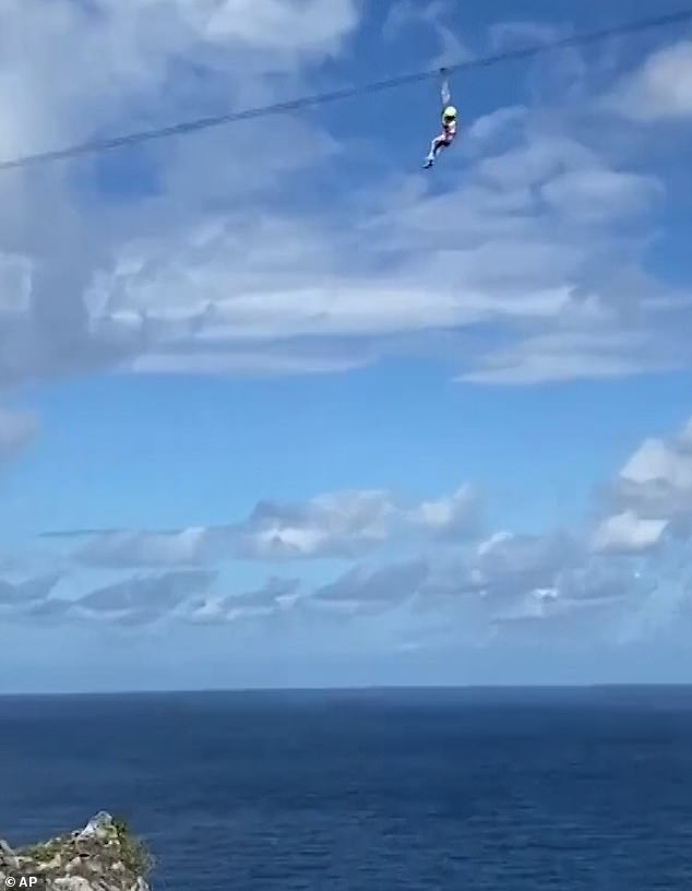 The girl's terrified and apparently crying mother, along with several British tourists, watched in horror from below as the child dangled 330 feet above the ocean in the July video.