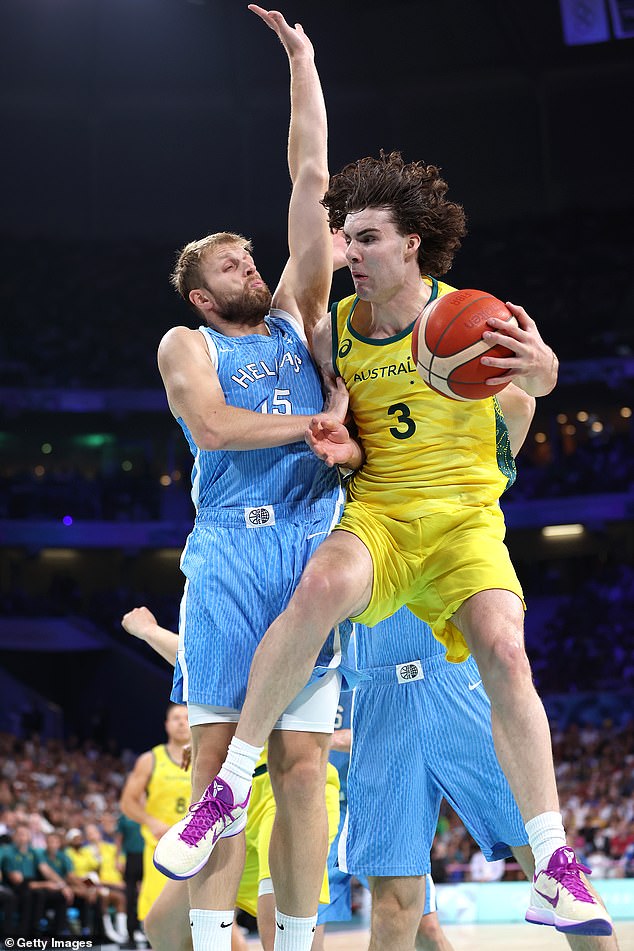 Australia's Josh Giddey had nine points and 10 rebounds after a slow first half (pictured: facing off against Vasilis Charalampopoulos)