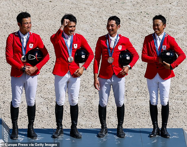 Ryuzo Kitajima, Yoshiaki Oiwa, Toshiyuki Tanaka and Kazuma Tomoto celebrate their bronze medal on the podium during the all-around team final