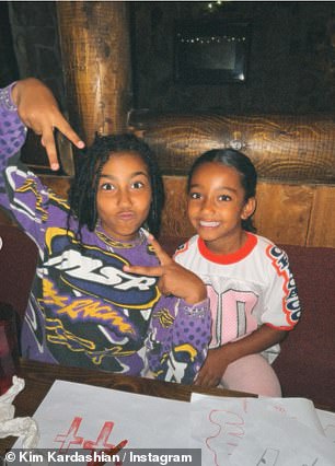 She included a fun triptych of her daughters North and Chicago sitting at the dining room table in front of their crayons and drawings on a spread of paper.