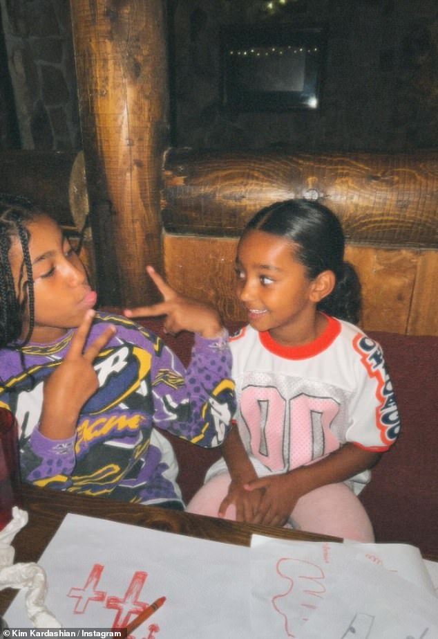 The sister duo flashed peace signs, flashing their matching bright smiles.