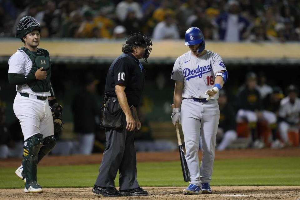 Dodgers' Will Smith talks to home plate umpire Phil Cuzzi after being called out on strikes during the eighth inning.